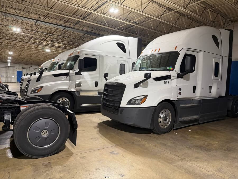 Late-model sleeper trucks lined up inside the Eastwind terminal